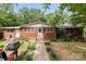 Charming single story brick home with a well maintained lawn, mature trees, and inviting front entrance at 16453 Nc Hwy 73 Hwy, Albemarle, NC 28001