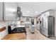 A kitchen featuring grey cabinetry, stainless steel appliances, a center island and mosaic tile backsplash at 16453 Nc Hwy 73 Hwy, Albemarle, NC 28001