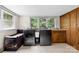 Bright laundry room features modern washer, dryer, cabinetry, and double windows overlooking the landscaped yard at 16453 Nc Hwy 73 Hwy, Albemarle, NC 28001