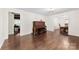 Open-concept living area with hardwood floors, piano, and access to dining room at 16453 Nc Hwy 73 Hwy, Albemarle, NC 28001