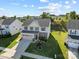 Aerial view of a beautiful two-story home featuring a well-maintained lawn and three-car garage at 1725 Mill Creek Sw Ln, Concord, NC 28025