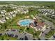 Aerial view showcasing the community pool, clubhouse, playground, and surrounding homes at 1725 Mill Creek Sw Ln, Concord, NC 28025