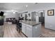 The basement is designed with an open layout featuring a kitchen island and cozy seating, perfect for entertaining guests at 1725 Mill Creek Sw Ln, Concord, NC 28025