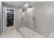 Modern bathroom featuring a glass-enclosed shower with dual shower heads, with a walk-in closet at 1725 Mill Creek Sw Ln, Concord, NC 28025