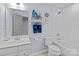 Clean bathroom with a tub and shower combination, complemented by nautical decor and a single sink vanity at 1725 Mill Creek Sw Ln, Concord, NC 28025