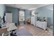 Light and airy bedroom with desk, complemented by white furniture and calming blue walls at 1725 Mill Creek Sw Ln, Concord, NC 28025