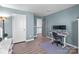Bedroom featuring desk area, complemented by white trim and calming blue walls at 1725 Mill Creek Sw Ln, Concord, NC 28025