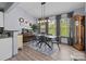 Elegant dining room with large windows, modern chandelier, and classic decor offers an inviting space for meals at 1725 Mill Creek Sw Ln, Concord, NC 28025