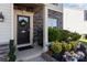 Inviting front entrance with stone accents, decorative wreath, and vibrant landscaping enhancing curb appeal at 1725 Mill Creek Sw Ln, Concord, NC 28025