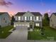 Charming two-story home featuring a well-maintained lawn, stone accents, and a spacious three-car garage at 1725 Mill Creek Sw Ln, Concord, NC 28025