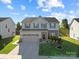 Charming two-story home featuring a well-maintained lawn, stone accents, and a spacious three-car garage at 1725 Mill Creek Sw Ln, Concord, NC 28025