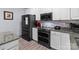 This kitchen showcases stainless steel appliances, sleek cabinetry, and stylish countertops, offering a modern and functional space at 1725 Mill Creek Sw Ln, Concord, NC 28025