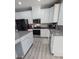 Modern kitchen with white cabinets, granite countertops, stainless steel appliances, and gray backsplash at 1725 Mill Creek Sw Ln, Concord, NC 28025