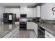 This is a functional kitchen with granite countertops, modern appliances, and ample cabinet space, ideal for cooking at 1725 Mill Creek Sw Ln, Concord, NC 28025