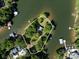 Aerial view of a waterfront property, bordered by mature trees and a pristine shoreline at 17835 Terryglass Ln, Charlotte, NC 28278