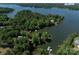 Stunning aerial shot showcases the home with lake access surrounded by mature trees at 17835 Terryglass Ln, Charlotte, NC 28278