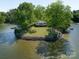 Aerial view showcasing a home on a private island with waterfront and dock at 17835 Terryglass Ln, Charlotte, NC 28278
