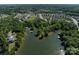 Expansive aerial shot shows the property near the lake surrounded by lush greenery at 17835 Terryglass Ln, Charlotte, NC 28278