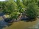 Aerial view showcasing a home on a private island with waterfront views and mature trees at 17835 Terryglass Ln, Charlotte, NC 28278