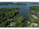 Scenic aerial view of lakefront property surrounded by lush trees, offering privacy and beauty at 17835 Terryglass Ln, Charlotte, NC 28278