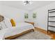 Cozy bedroom features hardwood floors, a comfortable bed, and two windows at 17835 Terryglass Ln, Charlotte, NC 28278