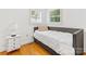 Simple bedroom with natural light, hardwood floors, and neutral colors at 17835 Terryglass Ln, Charlotte, NC 28278
