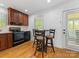 Eat-in kitchen featuring wood cabinets, black appliances, and hardwood floors at 17835 Terryglass Ln, Charlotte, NC 28278
