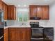 Cozy kitchen with wood cabinets, white backsplash, and modern appliances at 17835 Terryglass Ln, Charlotte, NC 28278