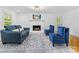 Cozy living room with a white fireplace, plush seating, and hardwood floors at 17835 Terryglass Ln, Charlotte, NC 28278