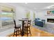Living space with eat-in table, leading to living room with fireplace and lake views at 17835 Terryglass Ln, Charlotte, NC 28278