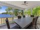 Covered porch boasts beautiful lake views, ideal for relaxation and outdoor dining at 17835 Terryglass Ln, Charlotte, NC 28278