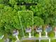Aerial shot showcases the property's expansive lot with mature trees and its location within a residential community at 200 Winter Flake Dr, Statesville, NC 28677
