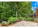 Charming backyard featuring a garden, patio, and lovely landscape with mature trees and greenery at 200 Winter Flake Dr, Statesville, NC 28677