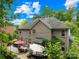 Spacious backyard features a brick home, a patio perfect for outdoor gatherings, mature trees, and lush greenery at 200 Winter Flake Dr, Statesville, NC 28677