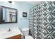 Cozy bathroom with blue walls, vanity, toilet, and shower with patterned curtain at 200 Winter Flake Dr, Statesville, NC 28677