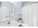 Well-lit bathroom features a white vanity and a shower with a white curtain at 200 Winter Flake Dr, Statesville, NC 28677
