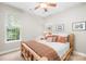 Comfortable bedroom features a ceiling fan and a large window offering natural light at 200 Winter Flake Dr, Statesville, NC 28677
