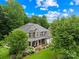 Attractive brick home featuring a manicured lawn, colorful flower beds, and a convenient two-car garage at 200 Winter Flake Dr, Statesville, NC 28677