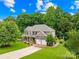 Charming two-story brick home with a well-manicured lawn, mature trees, and two-car garage at 200 Winter Flake Dr, Statesville, NC 28677