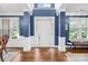 Elegant foyer featuring hardwood floors, white wainscoting, tall columns, and a bright entryway with natural light at 200 Winter Flake Dr, Statesville, NC 28677
