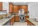 Updated kitchen featuring granite countertops, stainless steel appliances, and wooden cabinets at 200 Winter Flake Dr, Statesville, NC 28677
