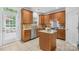 Gourmet kitchen with wood cabinetry, stainless steel appliances, and a convenient center island for meal prep at 200 Winter Flake Dr, Statesville, NC 28677