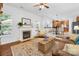 Inviting living room with fireplace, large windows, and an open view to the kitchen and dining area at 200 Winter Flake Dr, Statesville, NC 28677