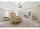 Large main bedroom features a sitting area, tray ceilings and neutral color palette at 200 Winter Flake Dr, Statesville, NC 28677