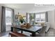 Bright dining area with stylish table, comfortable seating, and views of the living space and outdoors at 2024 Harlequin Dr, Indian Trail, NC 28079