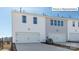 Modern townhouse exterior featuring attached garages, and a fenced yard at 2028 Harlequin Dr, Indian Trail, NC 28079