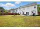 Expansive backyard with healthy green grass, privacy fence, and outdoor patio area with dining table at 2324 Oakdale Creek Ln, Charlotte, NC 28216