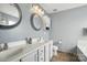 Bright bathroom with dual sinks, modern mirrors, and built-in storage at 2324 Oakdale Creek Ln, Charlotte, NC 28216