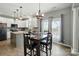 Bright dining area with modern lighting and views of the backyard at 2324 Oakdale Creek Ln, Charlotte, NC 28216