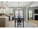 Open dining area connected to the kitchen featuring a table with backyard views at 2324 Oakdale Creek Ln, Charlotte, NC 28216